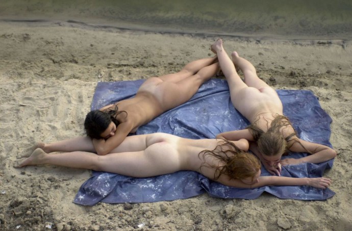 Naked men with women on the river