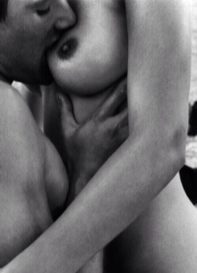 Man caresses female breasts