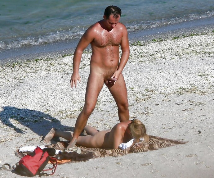 Naked men and women on the beach