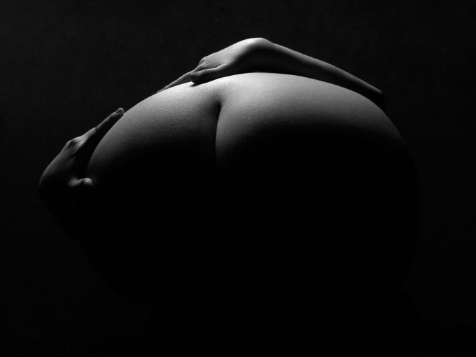 Naked butt on a black background