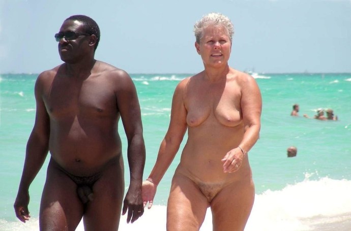 Naked elderly on the beach with blacks
