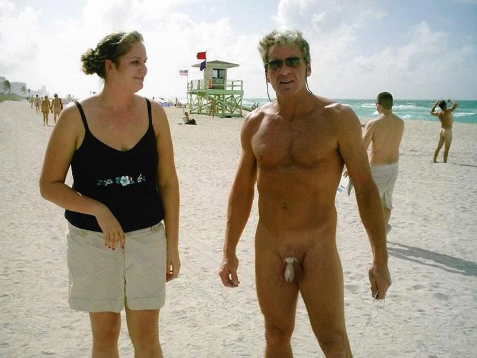 Naked on the beach among dressed