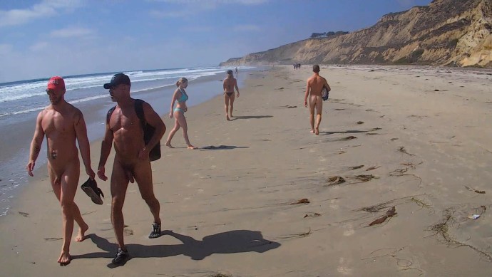 Dressed women naked guys on the beach