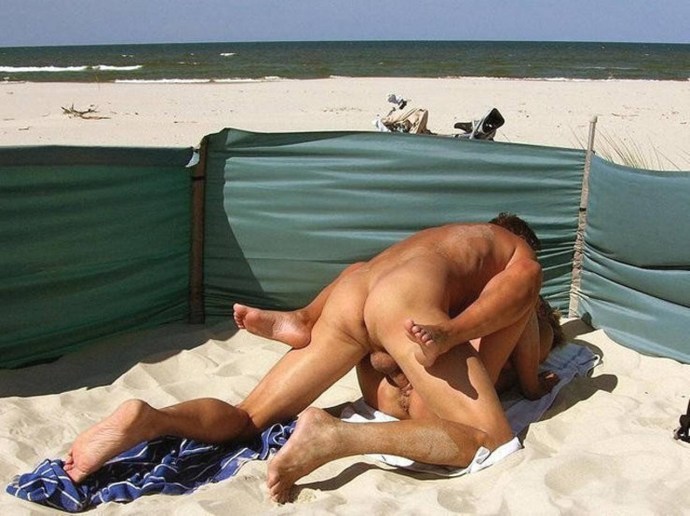 Naked men and women on the beach