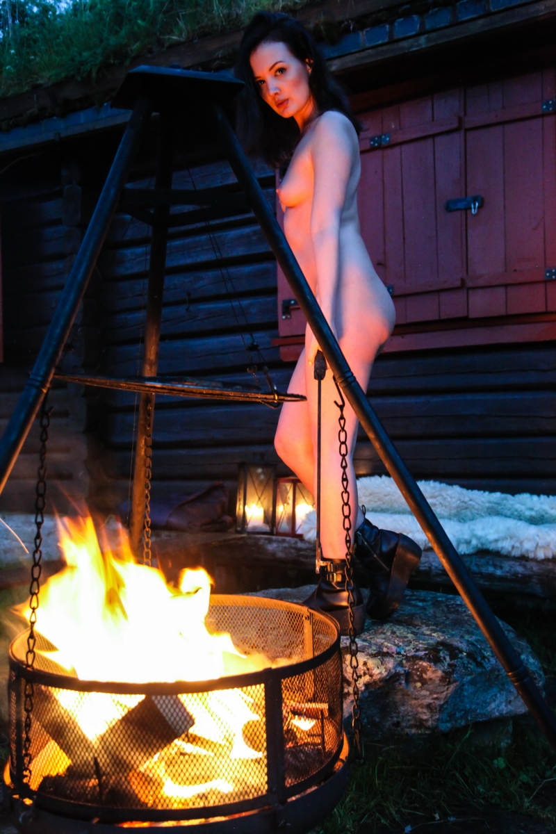 Naked woman near the fire